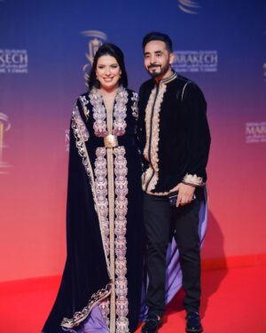 Mounia Lamkimel Instagram - @marrakechfilmfestival 
مع العمر @naamanadil 

حطيت الالبوم لي وصلني كااامل حيث ماعرفتش شنو نختار🫣 شكرا بزاااااف @tendancevision 
بغيت نقول شكرا لادارة المهرجان على حفاوة الاستقبال شكراً للاعلام المغربي على التتبع والمساندة 🇲🇦♥️
شكرا العزيزة الغالية @zor.creations  على اللبسة الهماوية لي تمتعت وانا لابساها ورغم الظروف الصحية والانشغالات إلا انك كنتي متمكنة من حرفتك ولبستيني أنا وعادل على أكمل وجه
شكرا من القلب اخويا وصديقي المتميز @halim_barakat_official لي ماكنتيق إلا فيه ولي شرف على الماكياج والشعر فوقت خرااافي وعطى نتيجة حبييييييتها😌♥️