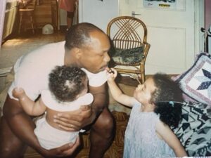 Ruby Barker Instagram - That’s my dad holding me as a baby while my sister does his lipstick 🤣