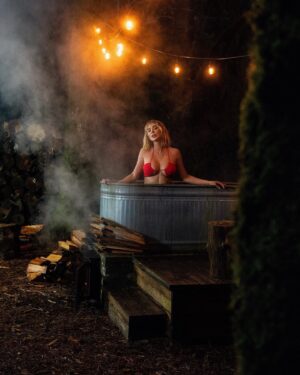 Sara Jean Underwood Instagram - Soaked til I couldn’t soak anymore in our hippie hot tub last night. Answers to the most asked questions about our handmade tub 👇🏻
“How long does it take to heat up?” - about an hour and a half. The wait is worth the reward.
“How do you not burn your bum?” - we built a removable wooden bench on the bottom, so the only parts of the metal that touches your body are the sides which don’t get hot.
“How do you control the temperature?” - When it starts getting too hot we have a hose nearby to fill it with cold water… or throw more logs on the fire if it’s getting too cold. It’s that simple 🤗
Hippie hot tub created by @jacobwitzling and @saraunderwood 
#woodfirehottub #diy #cabinlife