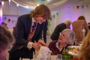Sarah Beeny Instagram - The @kingsfdn at @dumfrieshouse host monthly tea dances to bring together members of the local community at risk of loneliness or isolation to socialise while enjoying live music and an afternoon tea. 

When I visited @dumfrieshouse I was bowled over by how much care and professionalism the staff put into these dances, and so inspired. 

I am so grateful to the incredible Royal butlers, Evan and Gavin who helped us to host a similar event, the most joyous event I have ever had the privilege to host. 
Thank you so so much Evan, Gavin, @dumfrieshouse @kingsfdn and the wonderful @ageuksom team who trusted us with their 75th Anniversary party and to look after such precious guests. 
I don’t often say this and probably should say it more - thank you @the_entitled_sons ❤️xxxx. If you missed it, catch up on @channel4 #sarahbeenynewlife