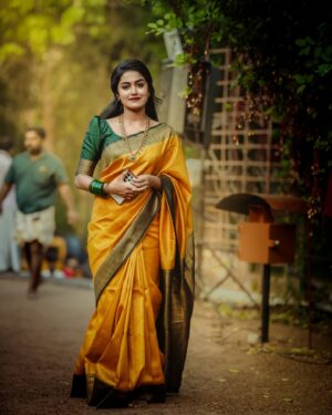 Haritha G Nair Instagram - 🌻🌻🌻
.
Costume : @canisaperidotclothing 
Ornaments : @canisaperidot 
MUA, Hair & Saree draping : @pink__passion_ 
Photography : @i_magics_photography_ 
.
#saree #SareeLove #IndianBeauty #TraditionalWear #GoldenSaree #DesiQueen #EthnicVibes #SareeNotSari #IndianCulture #graceful #elegantlook #FestiveMood #stylewithtradition #royalvibes