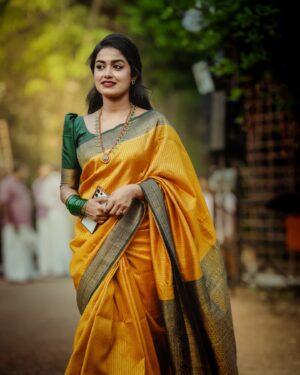 Haritha G Nair Instagram - 🌻🌻🌻
.
Costume : @canisaperidotclothing 
Ornaments : @canisaperidot 
MUA, Hair & Saree draping : @pink__passion_ 
Photography : @i_magics_photography_ 
.
#saree #SareeLove #IndianBeauty #TraditionalWear #GoldenSaree #DesiQueen #EthnicVibes #SareeNotSari #IndianCulture #graceful #elegantlook #FestiveMood #stylewithtradition #royalvibes