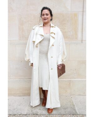 Lily Gladstone Instagram - Our dear friend @lilygladstone attending our Spring Summer 2025 show in Paris.
Lily wears an ivory textured linen slub Casper trench coat with watteau-back detail and ivory cashmere Knite knit dress from the Spring Summer 2025 paired with the cognac nappa leather Bocca boot and the chocolate nappa leather medium Leonora flap bag