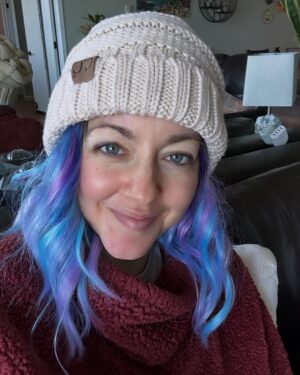 Dianna Cowern Instagram - Sitting in the living room. I had no idea when I’d get back to this point. I’m finally getting better. It feels relieving in a way I can’t describe. Also I love colorful wigs. 💜