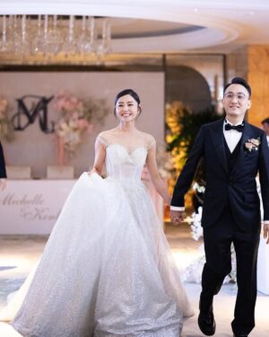 Michelle Wai Instagram - 唔經唔覺婚禮已經過咗兩星期，記得結婚當日，由起身一擘大眼嗰一刻開始，就好緊張同擔心。但係好幸運地一切都好圓滿，感激所有好朋友嘅幫忙，感激所有團隊高質素完美嘅配合，每一刻嘅畫面都充滿着愛同感動，雖然婚後對腳痛足三日，感覺好似拍咗三日打戲一樣，但都係值得嘅! ❤️

Hotel Venue: @islandshangrila
Hotel Deco: @bigdayweddingg 
Photography: @billyonairphotography
Emcee: @kissisis
Gowns: @trinitybridal #trinitybridal
High Heels: Silver ones/@giuseppezanotti, White ones/@christianlouboutin
Jewellery: @emperorjewellery 
Suit: @decon.tailormade 
Michelle&Kenley’s makeup: @make_up_by_mw 
Michelle&Kenley’s Hairstyling: @singsing113 
Bouquet: @bfflowers.boule.de.fleurs
Wedding Favors: @jomalonelondon @skinceuticals @lucullus_hk @shwedding.store