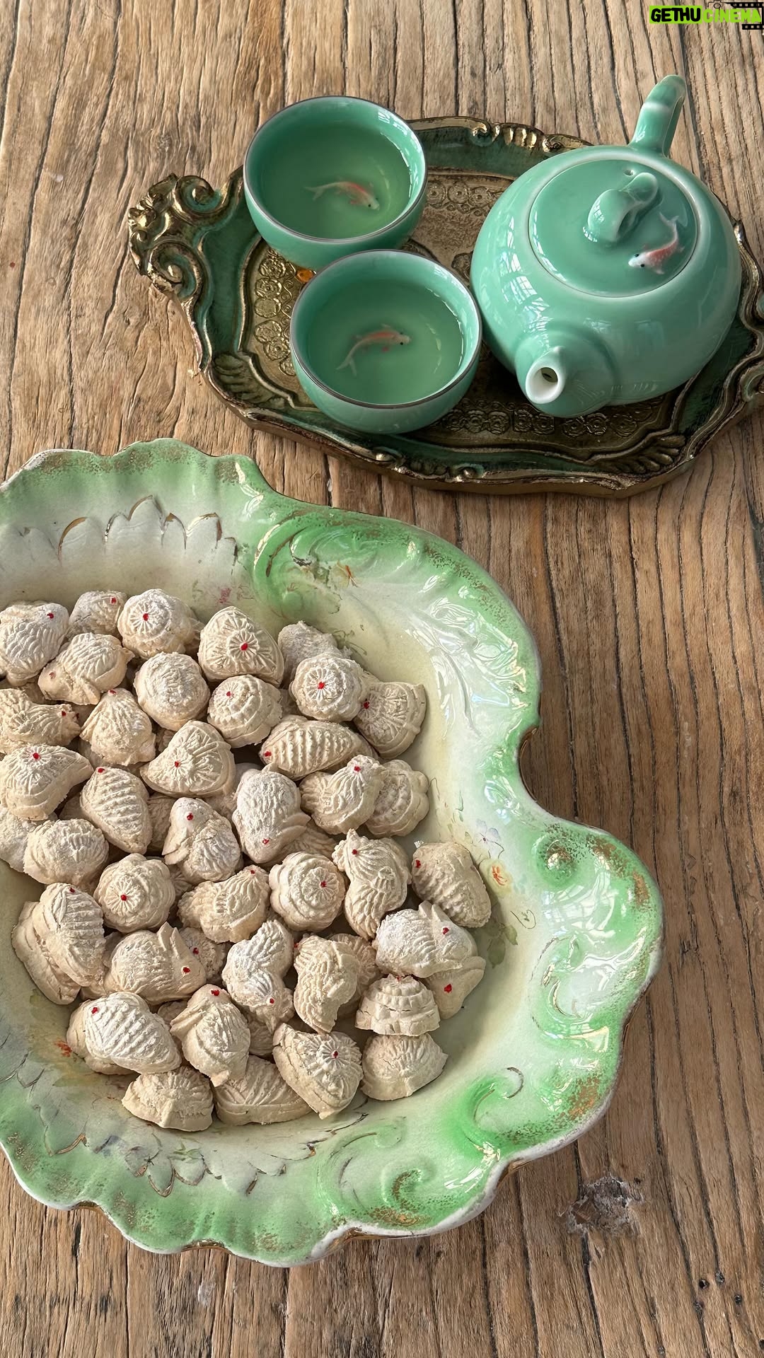 Poh Ling Yeow - 8.6K Likes - KUIH BANGKIT | Makes about 100 small biscuits
Gong Hei Fat Choi everyone! To celebrate, I’m sharing another Nyonya Chinese New Year treat that brings back many childhood memories. It’s also been lovely to use another traditional wooden mold I inherited from mum. Kuih Bankit is a pandan coconut flavoured biscuit made with roasted tapioca flour which gives it a unique melt in your mouth texture. ♥️
5 pandan leaves (found fresh or in frozen section of Asian grocers), cut into 6cm pieces
350g tapioca flour
1 large egg yolk
70g icing sugar
1/8 tsp salt
100-150g coconut cream, chilled in tin (Ayam brand if possible - found in most supermarkets)
Red food colouring
Preheat oven to 170*C FF. Scoop out only the thick part of the coconut cream which sits at the top of the tin and none of the liquid. Set aside.
Cover pandan leaves with tapioca flour in a baking tray or heatproof dish. Roast the flour for 2 hours. During this process mix with a spatula at least twice to make sure the flour is roasting evenly. Cool completely. Remove pandan & press, DON’T SHAKE flour through sieve or you will have a dust storm!
In a medium bowl whisk the icing sugar, yolk, salt & 100g of the coconut cream until combined (yes, this differs from the reel but a better way!). Whisk until soft & smooth. Add only 250g of the roasted tapioca flour. Squeeze together until the mix is just holding together as a single lump. If you take some mixture and squeeze it, it should just stay together but crumble easily when rubbed between your fingers. Add more coconut cream if needed. Cover with a moist towel.
Preheat oven at 150*C FF.
Dust the mold well with the leftover roasted tapioca flour before pressing in the dough firmly. Slice across the surface of the mold to remove excess dough. Knock the mold firmly on benchtop at an angle to remove the biscuits. Place them on a lined baking tray with 5mm gaps between biscuits. Bake for about 20 mins or until the centre is crisp. Cool then using a skewer or toothpick, decorate with dots of red food colouring. Store in airtight container for up to a month. Enjoy!
Top by @annie_parker_upcycling
