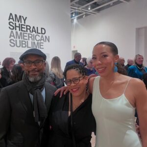 Amy Sherald Instagram - Still taking it all in…AMERICAN SUBLIME @whitneymuseum 🩵

This moment is bigger than me—and I’m honored to share it with all of you. #whitneymuseum #amysherald #americansublime #adventuresofkristinandamy 

Makeup @laramiemakeup  Hair @myssmonique  Red Dress Custom @harbison.studio With Harbison jewelry Second Opening Bracelet and Earrings @dinosaur_designs