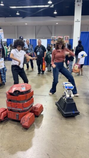 Emily Swallow Instagram - One might think, after all this dancing at conventions, I’d have some better moves. @ravicabotconyers did his best to teach me.

Clearly the peanut gallery droids wanted more.

#wondercon #everybodydancenow #theworm #ravicabotconyers #skeletoncrew #themandalorian #crossover #droids #starwars #emilyswallow #dancebreak