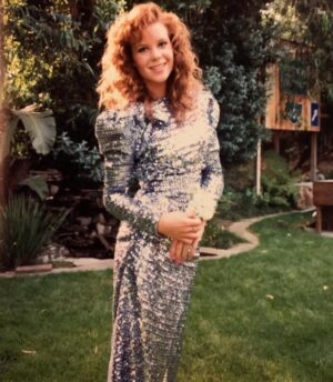 Robyn Lively Instagram - Yesss look at this prom queen y’all! I wasn’t really prom queen but I felt like one. My mom made this beautiful sequined gown and I loved it so much. 🩵 Here with my high school bf Craig. He was a football player at Granada Hills High. I always wanted to date a football player named Craig ;) and to be a cheerleader. The closest I ever got to being a cheerleader was in Teen Witch. I LOVED my cute purple outfit and pleated white skirt in that scene. Sigh… This was a much simpler time. Music, big hair, and shoulder pads ruled!! Also kinda still loving those nails tbh. Happy #tbt #80s #prom