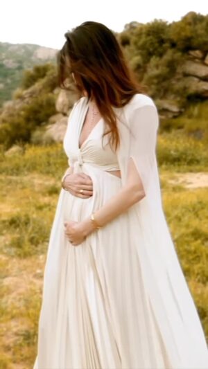 Christina Pascucci Instagram - Breaking news! Baby coming this fall 🤍

And yes, that means our babies will be pretty close in age— about 17 months 🆘

I have so much to share about this pregnancy that I’ll do at the right time. For now I just want to say— thank you, God. We are so grateful. 

Do you think it’s a boy or girl!?

Thank you to the oh so talented @hamidmoslehiphotography, for capturing this moment!

And just realized the cover I’m wearing with this dress is designed by my friend who is exceptionally talented. How special to have you with me in this moment @katiemaycollection