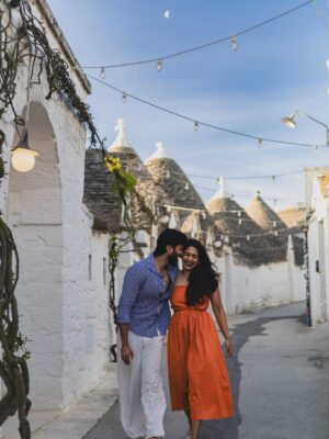 Rebecca Roy Instagram - 📍Alberobello in one magical morning!

This UNESCO World Heritage town in Puglia is famous for its Trulli — cone-roofed houses built entirely without mortar. These stone homes date back to the 14th century and were once designed to be easily dismantled to avoid taxes!

In just a few hours, we:
• Wandered through quiet Trulli lanes under the morning moon
• Learned about their fascinating architecture and history
• Explored charming local shops inside the Trulli
• Tried local wines, fig jams & olive oil
• Soaked in that golden morning light that made the whole town glow

Tip: We stayed in an actual Trulli at @tipicoresortalbergo — and highly recommend spending a night (or two!) here instead of doing a day trip.
Waking up early and catching the peaceful streets before the crowds arrive? 100% worth it.

Travel by @gtholidays.in 

All content is self shot 

#Alberobello #TrulliExperience #PugliaTravel #UNESCOWorldHeritage #coupletravel #ItalyHiddenGems #TipicoResort #TrulliStay #SlowTravelEurope #AlberobelloTips #chennaiinfluencer