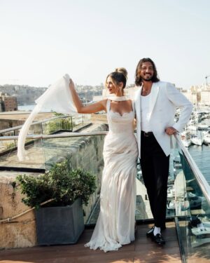 Delta Goodrem Instagram - EXCLUSIVE: Delta Goodrem’s wedding celebrations began with a breathtaking welcome dinner at The Sheer Bastion @cugo_gran_macina in Malta - and we have the first look. From the moment guests arrived to the sound of Frank Sinatra and Nat King Cole, it was clear this wasn’t just any wedding week. It was going to be unforgettable.
Dressed in a custom @antoinettefusillo gown - a soft blush lace creation that “felt like it was dancing with me through the night,” Delta set the tone for a week of love, joy and full dance floors. Paired with pale pink @lanawilkinsonofficial heels, @antonjewellery diamonds and a deep plum lip by makeup artist @nonismithmakeup, the look was pure modern romance. Styled by @meggysmithstylist every detail was effortless elegance.
Guests were treated to flowing champagne, fresh canapés and a live performance from Maltese artist Kevin Paul. “Everyone was dancing and singing up a storm,” Delta tells us. “It was the perfect first chapter.”
Captured by @mattporteous and @becky_lee_brun, with planning by @sarahyoungevents and @thisiswonderevents, these moments were pure magic. Head to the link in bio for every exclusive detail.