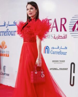 Feriel Graja Instagram - All red on red ❤️
I had the pleasure of being honoured at Baghdad's arts festival 
Styled by @mayajules 
Dress @yousef_aljasmi 
Glam by @bana_aga 
Bag @dior 
#iraq #festival #actress #redcarpet