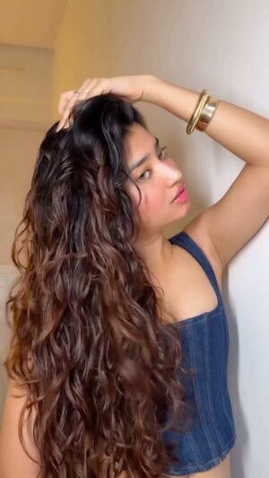 Ria Amin Instagram - It took me 24 years to realize I have wavy hair 😮‍💨

Initially, I wore a wig and that dramatic fire symbolized the years of damage I’ve caused to my real hair with excessive straightening. Please, don’t try this at home!

Products used :
1.) @letscurlupdotcom hair defining cream 
2.) @fiixmycurls glaze defining hair gel 

Comment for the products link