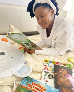 Zenande Mfenyana Instagram - This is definitely one of our fave pastimes with my Ballerina. Also, I get to sneak in some tummy time for her 😍📖