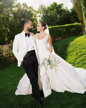 Amina Khalil Instagram - On the most important day of her life, #AminaKhalil stepped into her forever, surrounded by towering palms and a sea of white. For this deeply personal celebration, she wears a custom creation by Maison Yeya: a modern interpretation of a timeless princess silhouette. Designed by Yasmine Yeya, the gown sculpted her figure before cascading into voluminous layers of triple silk gazar, delicately embroidered at the hem. Captured exclusively for Vogue Arabia, the first glimpse of an Egyptian actress revealing a modern bridal vision.

في أهم يومٍ في حياتها، أطلت أمينة خليل كحلمٍ محاطةً بسحر النخيل الباسق ونقاء الأبيض الناصع. لحفلها زفافها، تألقت أمينة بفستان من "ميزون يحيى"، صُمم خصيصًا ليجعل منها أميرةً عصريةً خالدة. احتضن الفستان، الذي أبدعت ياسمين يحيى بتصميمه، قوامها قبل أن يتدفق على طبقاتٍ شاسعة من الغازار الحريري، مطرزًا بدقةٍ عند الأطراف. وفي صورٍ حصرية لمجلة ڤوغ العربية، تلوح أول لمحةٍ لممثلةٍ مصريةٍ تكشف رؤيةٍ عصريةٍ لفساتين الزفاف.

Photography: @lamismagdy 
Stylist: @mohamedashraff
Makeup: @Itsnohathemua
Hair: @kimisafadi 
Dress: @maisonyeya 
Shoes: @jimmychoo 
Jewellery: @elkadyjewelry 
Event planning: @vertex.events 

#VogueArabia