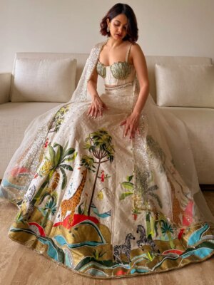 Anandita Pagnis Instagram - Step into our whimsical world of hand-painted giraffes, zebras, and banana trees, amidst buzzing fireflies and majestic cockatoos. Our Golden Earth Hand-painted Lehenga Set brings the Jungle Book to life on rich raw silk, with metallic gold tones and intricate embroidery that shines like the night sky. Every detail is a brushstroke of magic, every thread a whisper of wonder 🦓🌴🦒🌿🏝️🪺🔱

[World of Anush, Bespoke, Lehenga Set, Corset, Floral, Hand embroidery, Hand Painting] 

#worldofanush #bespoke #lehenga #corset #instagram #fyp