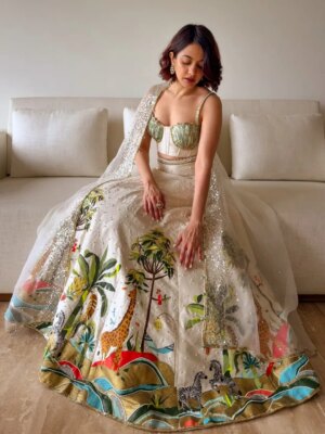Anandita Pagnis Instagram - Step into our whimsical world of hand-painted giraffes, zebras, and banana trees, amidst buzzing fireflies and majestic cockatoos. Our Golden Earth Hand-painted Lehenga Set brings the Jungle Book to life on rich raw silk, with metallic gold tones and intricate embroidery that shines like the night sky. Every detail is a brushstroke of magic, every thread a whisper of wonder 🦓🌴🦒🌿🏝️🪺🔱

[World of Anush, Bespoke, Lehenga Set, Corset, Floral, Hand embroidery, Hand Painting] 

#worldofanush #bespoke #lehenga #corset #instagram #fyp