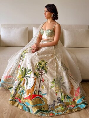 Anandita Pagnis Instagram - Step into our whimsical world of hand-painted giraffes, zebras, and banana trees, amidst buzzing fireflies and majestic cockatoos. Our Golden Earth Hand-painted Lehenga Set brings the Jungle Book to life on rich raw silk, with metallic gold tones and intricate embroidery that shines like the night sky. Every detail is a brushstroke of magic, every thread a whisper of wonder 🦓🌴🦒🌿🏝️🪺🔱

[World of Anush, Bespoke, Lehenga Set, Corset, Floral, Hand embroidery, Hand Painting] 

#worldofanush #bespoke #lehenga #corset #instagram #fyp