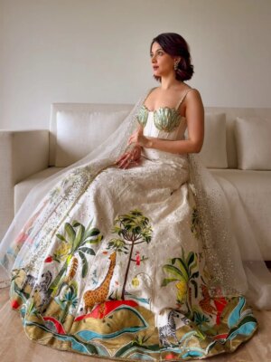 Anandita Pagnis Instagram - Step into our whimsical world of hand-painted giraffes, zebras, and banana trees, amidst buzzing fireflies and majestic cockatoos. Our Golden Earth Hand-painted Lehenga Set brings the Jungle Book to life on rich raw silk, with metallic gold tones and intricate embroidery that shines like the night sky. Every detail is a brushstroke of magic, every thread a whisper of wonder 🦓🌴🦒🌿🏝️🪺🔱

[World of Anush, Bespoke, Lehenga Set, Corset, Floral, Hand embroidery, Hand Painting] 

#worldofanush #bespoke #lehenga #corset #instagram #fyp