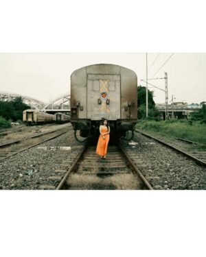 Asmee Ghosh Instagram - In a world that never stops moving, I chose to pause to lean into my own rhythm, to stand boldly where stories pass and silence speaks louder than noise. Draped in hues, wrapped in grace, I’m not waiting for a train, a sign, or permission! just owning the tracks I walk and the fire I carry. I don’t blend in with the blur, I break it. While the world rushes past, I stand still, sharp, and unbothered. Against cracked walls and iron rails, I wear my fire loud and my silence louder. This isn’t softness, it’s strength wrapped in calm. I’m not here to be delicate. I’m here to be unforgettable. Watch the train pass. I’ll still be standing. Rooted to the earth. Miles to go before I sleep….

Behind the lens @swaratghosh 🧡