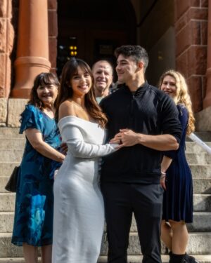 Aurélie Moeremans Instagram - On December 30th, we decided to get our marriage license sorted out at the Old Orange County Courthouse so that by the time our big wedding in April rolls around, we can fully enjoy the moment without worrying about paperwork. We thought it was just going to be signing some documents and that’s it—but to our surprise, after signing, the clerk said, ‘Alright, now let’s head to the altar for the ceremony.’ 😅

We weren’t planning for any kind of ceremony and even told her that, but she explained it’s part of the process to make it official. Luckily, I had the random thought to wear a white dress that day—it wasn’t fancy, but at least it felt fitting! Tyler’s mom, dad, and sister were there to support us, which made the moment even more special.

So there we were, doing an impromptu courthouse ceremony. It was simple, unexpected, and unplanned, but also sweet in its own way. Now, we’re officially married, but we’re still looking forward to our big wedding in April with a beautiful ceremony, and a celebration with all our family and friends. Can’t wait to share that moment with you all!

📸 @reagan_dambra