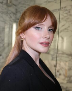 Bryce Dallas Howard Instagram - Thank you #SXSWLondon for hosting the world premiere of Deep Cover — right in Shoreditch, in the very neighborhood where we filmed, surrounded by the team who brought it to life.

This film is a love letter to improv, to London, and to every cast and crew member who poured their talent and heart into it. 

#DeepCover streams June 12 on @primevideo.

Hair: @halleybrisker
Makeup: @nikki_makeup
Nails: @veenailz

📸 1-2, 7-8: @nikki_makeup
📸 3-5: Getty Images for SXSW London
📸 6: Anthony Harvey/Shutterstock for Amazon Prime Video

[ID: BDH poses for portraits wearing a navy blue @sandroparis sweater with rows of silver buttons on the front on a light blue ruffle collar.  

At the @sxswlondon premiere of Deep Cover, she stands alongside the cast and crew in a black @sandroparis striped three-piece suit with sequins and @stuartweitzman heels. Her hair is straight and falls behind her shoulders. 

And before the premiere, the trio (BDH, Orlando, and Nick) surprise an improv class at the legendary @comedystorelondon and take a photo on the iconic blue-curtained stage. BDH wears a grey @majeparis sweater with a lace collar, @mother jeans, and her silver @rebeccaminkoff pumps.]