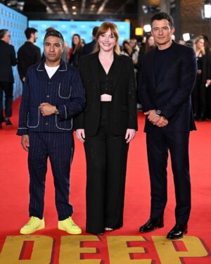 Bryce Dallas Howard Instagram - Thank you #SXSWLondon for hosting the world premiere of Deep Cover — right in Shoreditch, in the very neighborhood where we filmed, surrounded by the team who brought it to life.

This film is a love letter to improv, to London, and to every cast and crew member who poured their talent and heart into it. 

#DeepCover streams June 12 on @primevideo.

Hair: @halleybrisker
Makeup: @nikki_makeup
Nails: @veenailz

📸 1-2, 7-8: @nikki_makeup
📸 3-5: Getty Images for SXSW London
📸 6: Anthony Harvey/Shutterstock for Amazon Prime Video

[ID: BDH poses for portraits wearing a navy blue @sandroparis sweater with rows of silver buttons on the front on a light blue ruffle collar.  

At the @sxswlondon premiere of Deep Cover, she stands alongside the cast and crew in a black @sandroparis striped three-piece suit with sequins and @stuartweitzman heels. Her hair is straight and falls behind her shoulders. 

And before the premiere, the trio (BDH, Orlando, and Nick) surprise an improv class at the legendary @comedystorelondon and take a photo on the iconic blue-curtained stage. BDH wears a grey @majeparis sweater with a lace collar, @mother jeans, and her silver @rebeccaminkoff pumps.]
