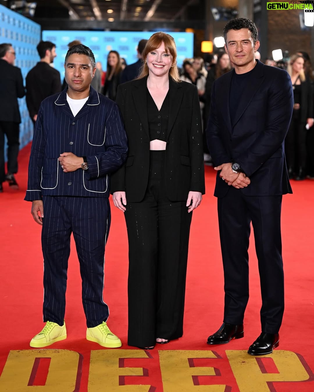 Bryce Dallas Howard - 468.8K Likes - Thank you #SXSWLondon for hosting the world premiere of Deep Cover — right in Shoreditch, in the very neighborhood where we filmed, surrounded by the team who brought it to life.

This film is a love letter to improv, to London, and to every cast and crew member who poured their talent and heart into it. 

#DeepCover streams June 12 on @primevideo.

Hair: @halleybrisker
Makeup: @nikki_makeup
Nails: @veenailz

📸 1-2, 7-8: @nikki_makeup
📸 3-5: Getty Images for SXSW London
📸 6: Anthony Harvey/Shutterstock for Amazon Prime Video

[ID: BDH poses for portraits wearing a navy blue @sandroparis sweater with rows of silver buttons on the front on a light blue ruffle collar.  

At the @sxswlondon premiere of Deep Cover, she stands alongside the cast and crew in a black @sandroparis striped three-piece suit with sequins and @stuartweitzman heels. Her hair is straight and falls behind her shoulders. 

And before the premiere, the trio (BDH, Orlando, and Nick) surprise an improv class at the legendary @comedystorelondon and take a photo on the iconic blue-curtained stage. BDH wears a grey @majeparis sweater with a lace collar, @mother jeans, and her silver @rebeccaminkoff pumps.]