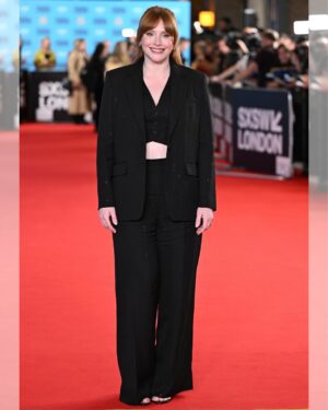 Bryce Dallas Howard Instagram - Thank you #SXSWLondon for hosting the world premiere of Deep Cover — right in Shoreditch, in the very neighborhood where we filmed, surrounded by the team who brought it to life.

This film is a love letter to improv, to London, and to every cast and crew member who poured their talent and heart into it. 

#DeepCover streams June 12 on @primevideo.

Hair: @halleybrisker
Makeup: @nikki_makeup
Nails: @veenailz

📸 1-2, 7-8: @nikki_makeup
📸 3-5: Getty Images for SXSW London
📸 6: Anthony Harvey/Shutterstock for Amazon Prime Video

[ID: BDH poses for portraits wearing a navy blue @sandroparis sweater with rows of silver buttons on the front on a light blue ruffle collar.  

At the @sxswlondon premiere of Deep Cover, she stands alongside the cast and crew in a black @sandroparis striped three-piece suit with sequins and @stuartweitzman heels. Her hair is straight and falls behind her shoulders. 

And before the premiere, the trio (BDH, Orlando, and Nick) surprise an improv class at the legendary @comedystorelondon and take a photo on the iconic blue-curtained stage. BDH wears a grey @majeparis sweater with a lace collar, @mother jeans, and her silver @rebeccaminkoff pumps.]