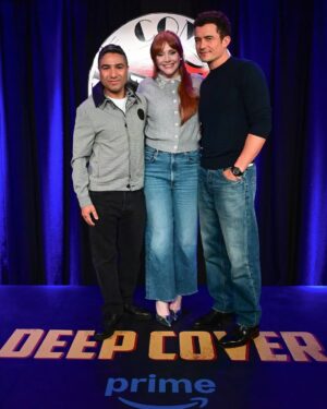 Bryce Dallas Howard Instagram - Thank you #SXSWLondon for hosting the world premiere of Deep Cover — right in Shoreditch, in the very neighborhood where we filmed, surrounded by the team who brought it to life.

This film is a love letter to improv, to London, and to every cast and crew member who poured their talent and heart into it. 

#DeepCover streams June 12 on @primevideo.

Hair: @halleybrisker
Makeup: @nikki_makeup
Nails: @veenailz

📸 1-2, 7-8: @nikki_makeup
📸 3-5: Getty Images for SXSW London
📸 6: Anthony Harvey/Shutterstock for Amazon Prime Video

[ID: BDH poses for portraits wearing a navy blue @sandroparis sweater with rows of silver buttons on the front on a light blue ruffle collar.  

At the @sxswlondon premiere of Deep Cover, she stands alongside the cast and crew in a black @sandroparis striped three-piece suit with sequins and @stuartweitzman heels. Her hair is straight and falls behind her shoulders. 

And before the premiere, the trio (BDH, Orlando, and Nick) surprise an improv class at the legendary @comedystorelondon and take a photo on the iconic blue-curtained stage. BDH wears a grey @majeparis sweater with a lace collar, @mother jeans, and her silver @rebeccaminkoff pumps.]