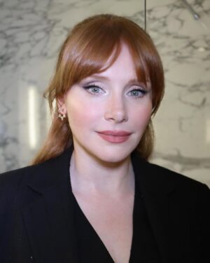 Bryce Dallas Howard Instagram - Thank you #SXSWLondon for hosting the world premiere of Deep Cover — right in Shoreditch, in the very neighborhood where we filmed, surrounded by the team who brought it to life.

This film is a love letter to improv, to London, and to every cast and crew member who poured their talent and heart into it. 

#DeepCover streams June 12 on @primevideo.

Hair: @halleybrisker
Makeup: @nikki_makeup
Nails: @veenailz

📸 1-2, 7-8: @nikki_makeup
📸 3-5: Getty Images for SXSW London
📸 6: Anthony Harvey/Shutterstock for Amazon Prime Video

[ID: BDH poses for portraits wearing a navy blue @sandroparis sweater with rows of silver buttons on the front on a light blue ruffle collar.  

At the @sxswlondon premiere of Deep Cover, she stands alongside the cast and crew in a black @sandroparis striped three-piece suit with sequins and @stuartweitzman heels. Her hair is straight and falls behind her shoulders. 

And before the premiere, the trio (BDH, Orlando, and Nick) surprise an improv class at the legendary @comedystorelondon and take a photo on the iconic blue-curtained stage. BDH wears a grey @majeparis sweater with a lace collar, @mother jeans, and her silver @rebeccaminkoff pumps.]