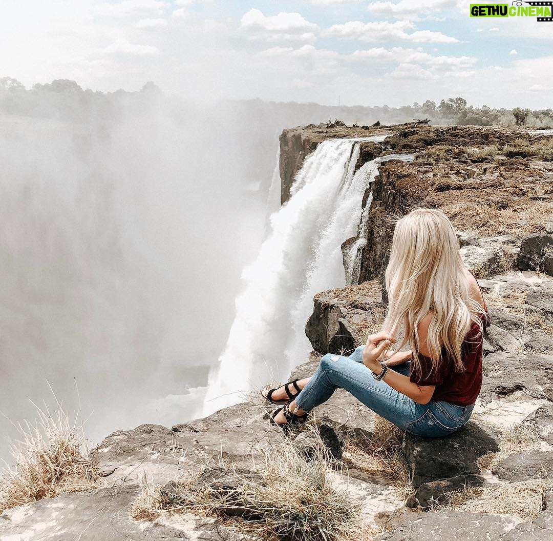 Cassidy Wolf - 2.3K Likes - Reminiscing to the one time I flew over & sat on the edge of Victoria Falls in Zambia... Bucket List ✔️