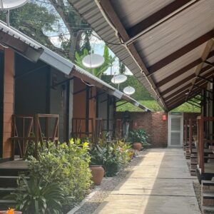 Emelda Rosemila Instagram - Part 1.
Persinggahan yg penuh emosi.

Karai. Nama sebuah tempat yg tersemat indah dlm ingatan mel sejak kecil. Salah satu tempat yg ada dlm bucket list yg mel nak re-visit. Tempat tinggal atuk & nenek saudara yg menjadi tempat favorite mel masa kecik2 sbb ada sungai. Tahun 80an. Mel masih sekolah rendah. Bila ayah-ngah ( abg mama mel ) balik ipoh dari KL, Karai menjadi destinasi wajib. Dia akan ajak opah mel and angkut mel sekali klu cuti sekolah. Mmg suka sgt dpt pergi rumah tokcik, sbb boleh mandi sungai berejam2 smpai kena marah baru naik, jari smpai kecut2. Tapi, perjalanan menuju ke Karai tu mel tak suka, belum ada highway so kena guna jalan lama sungai siput, kdg klu bertolak malam, gelap ya amat, dikelilingi hutan & hanya bercahayakan bulan & bintang.

Dah smpai Karai pun, kena park kereta kat atas bukit, lepas tu kena jalan kaki turun bukit sbb takde laluan kereta. Jalan denai kecik jer, kiri kanan sawah padi dalam hutan banat gelap gelita. Kena menyelusuri jalan2 kecik utk sampai ke rumah tokcik yg terpencil dlm hutan. Kiri kanan tak ada rmh org. Rmh semua jauh2. 10 minit jugakla nak jalan. Mel mesti tutup mata peluk opah ketat2. Mel masih ingat perjalanan dan pengalaman itu dgn jelas, sbb ia memerlukan kekuatan mental yg tinggi utk smpai ke rumah tokcik utk budak 9 - 10 tahun. Menakutkan.😅

Rmh tokcik takde letrik. Takde tv. Klu mlm pasang lampu minyak tanah. Sebak bila membayangkan wajah2 kesayangan duduk melingkar, berbual sambil menikmati kopi kampung pekat. Gelak tawa mereka menjadi muzik indah dalam malam yg sunyi, hanya bertemankan lampu minyak tanah borak sampai lewat malam. Mel akan baring diriba opah sambil dengar org dewasa berborak. Gelak ketawa dorang masih segar dlm ingatan. Serba tak cukup, tapi sgt2 bahagia.🥹

Bila siang, dari pagi dah paksa opah & atuk bwk mandi sungai. Terpaksala dorg melayan. Klu mandi dgn atuk best sbb dia kelakar selalu entertain dgn lawak2 dia. Dia pandai tangkap udang2 kecik lepas tu terus makan. Fresh katanya😅. 

Sambung part 2.