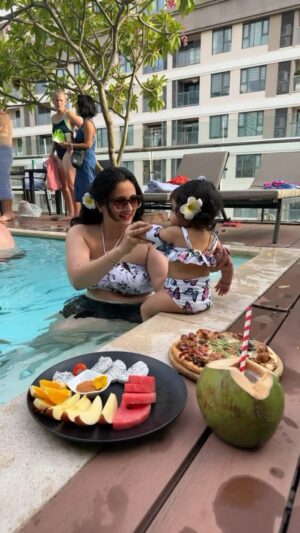 Harshika Poonacha Instagram - Princess Tridevi Ponnakkaah is Officially a Water Baby 🥰 
My baby’s first pool experience ♥️♥️♥️
She loves water just like her parents♥️
VC @bhuvann_ponnannaa_official 
#princess #trideviponnakkaah #harshikapoonacha #bhuvanponnanna #newmom #love #fathersday #parents #vacation #vietnam #hochiminh 
.
.
.
.
.
.
.
.
.
Thankyou @paragonsaigon.hotel for having such a lovely pool and super glad we connected with @trawel_mart for booking us the stay for this vacation.
Totally worth it ♥️
PS : The food was amazing , The #chickenpizza you see on the video was out of the world 💕