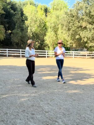 Kelly Noonan Instagram - On Friday after a heavy two days I did Equine Therapy with my brilliant facilitator @kateneliganequinecoach.
Horses are so sensitive. So good. So beautiful. But their wildness, strength, and size has always scared me. I first started doing equine therapy to get over my fear of horses but what has unfolded and what heals every time I work with horses has been massive, awe-inspiring, and mystical.
Horses hearts are five times the size of humans and they give off an electro-magnetic field that is healing just to be in the presence of. But they also tune into our energy and start to behave in ways that reflect back what they are picking up in our energetic field.
The beautiful spotted horse named Pico worked with my head space to remove old disempowering thought patterns and story loops. He also worked on my back and shoulder where I carry a lot of tension and unexpressed emotion. He also stood over me to experience receiving protective energy. That one hit deep. So much more transpired but I cried much needed tears. Grieving some personal heartache, some sadness around some very close family members dealing with gnarly stuff, and the collective heaviness of what’s been happening this week.
I had profound “aha’s” working with the horses but some of the takeaways were:
- I am moving into a new space with a higher perspective
- Joy and play are extremely important to my creativity and work, as that is my essence
- Be present, grounded in the presence of big energies and trust that I can handle it all and that I am worthy of receiving the love, protection, and abundance that life is presenting.
If this resonates, I highly encourage trying equine therapy. It’s incredible for trauma, neuro divergence and highly sensitive people, emotional and energetic roots of physical dis-eases, heartbreak, big transitions and so much more. Much love xx
