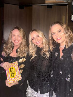 Mia Freedman Instagram - For the last two years, @joeythelabel has dressed us for the @mamamiaoutloud live shows. 
This has meant that @wainwrightholly @jessiestephens90 and I have not had to think about our clothes for a second because we always feel so special and comfortable in our Joey outfits. They just look so good. And she designs for real women’s bodies. 
@joeythelabel is a small, independent Australian business founded by Jo Trotter who is doing it tough after the sudden loss of her sister and has had to take some time from her business. 
As any business owner knows, this is perilous because you don’t get any kind of leave or holidays - the buck stops wtrh you.
So to keep her beloved business afloat Jo is having a big sale. So if you’ve ever thought about buying something from her, now is the time.
I’ve been collecting @joeythelabel pieces for years - and I am proud to own many of her iconic designs. She brings such sparkle and joy to her clothes, I feel so fantastic  every time I put on something Jo has designed. She somehow manages to make classic pieces that are also just so fun and unlike what everyone else does. 
If you can, please support her - and all small businesses founded and run by women - whenever you can. It makes all the difference in the world…. ❤️❤️❤️❤️