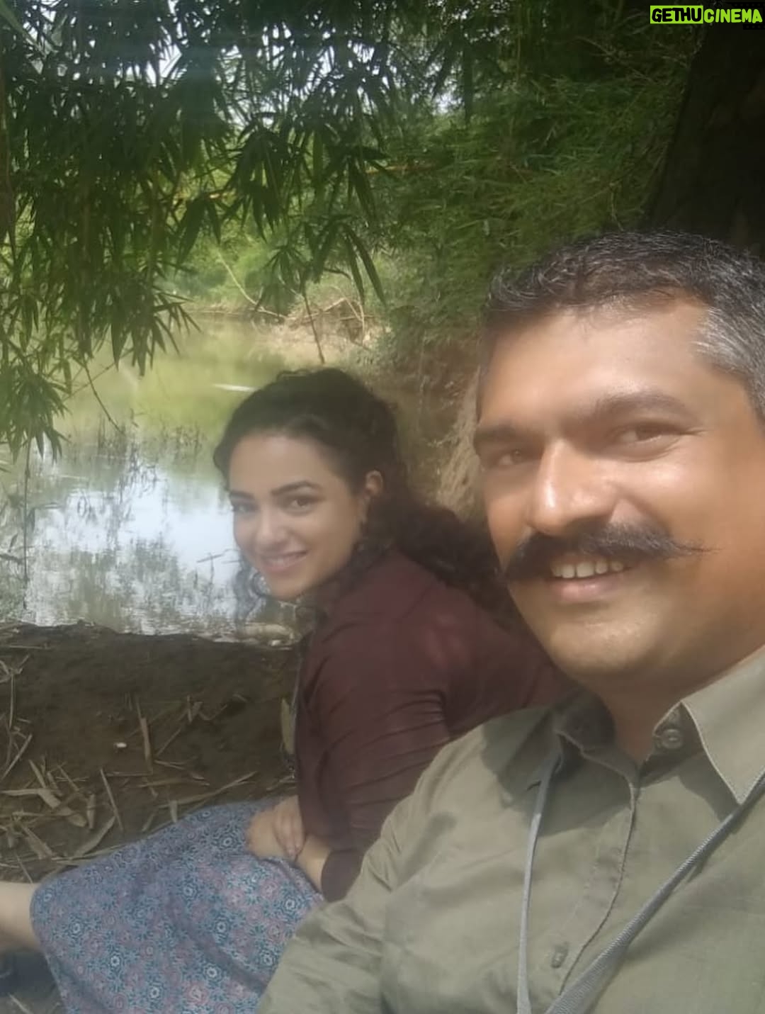 Nithya Menen - 1.4 Million Likes - There are some moments (that come rarely) when I feel very nourished by a movie. Simply because it was real cinema… and I could engage the artist in me. I could really do the work that I was always meant to do , but get to do so little of :)
One of those movies is ‘Kolaambi’ directed by @tkrajeevkumar . And it is, to date, one of the few films I’ve done that I know will stand the test of time. Because art lives on and never gets old, and never changes. I still remember well, the day Rajeev sir came to see me in Bangalore at my home to talk to me about this film. It sounded like a real film. Like it had a beating heart. I didn’t need even a moment to think about it. 
And as I expected, I loved working on the film and the people there - The ‘Agrahaaram’ we shot in - where the people would greet us every morning as they went about their everyday routine. We were now just a part of their routine and they would treat us so casually- which I LOVED! No unnecessary intrusion, attention, excitement regarding films or actors or  shooting. What a dream that was- to go about our work normally. We made sure we were as respectful as possible too- keeping silence, eating vegetarian food and keeping the place clean . 
The spunky ‘Paati’ who kept me company while I was waiting in-between shots. She shared her home, her stories and most of all- her AC with us :D
After a week, I found our Line Producer Sujit Soman sitting on her dining table at the far end of her house, eating his meals. They let us do that. They shared everything. 
The river at the end of the road to the Agrahaaram that I would walk up to whenever I had some time . It was a dream to be so close to nature which, truth be told, is the thing I enjoy most. 
And our communal meals in that same restaurant in Fort Cochin! @iamsijoyvarghese @siddharth2121 @r_varman_ and I . We would put all the food in the middle and eat straight off the same bowl. I miss that very much. I felt like myself & I took away something big from it, thanks to Sijoy :)
I hope I have more of this in the days and years to come - these kind of films and these kind of people 🌺
@renji_panicker @rohinimolleti @dileeshpothan @resulpookutty @sabu_cyril