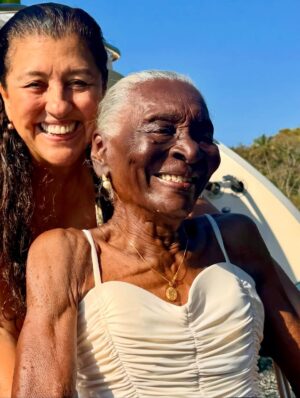 Regina Casé Instagram - Olha que delícia essa batedeira no pôr do sol na Ilha Grande, genteee!!!

Quem vê esse cara assim não imagina quantas outras coisas ele sabe fazer tão bem. Cuidar da avó, cuidar da mãe, das tias, da família todinha...

É muito impressionante a criação que esse menino teve, a educação que ele recebeu de todas essas mulheres... É lindo demais ver as duas coisas convivendo juntas. 

A batedeira e a trezena de Santo Antônio.

A batedeira e ele honrando sua ancestralidade no Candomblé da sua tia.

A batedeira e ele trabalhando a vida toda com sua mãe, ajudando ela no seu tabuleiro de acarajé.

A batedeira e o cuidado que ele teve com a Preta e que agora tem comigo, a educação esmerada.

Foi uma maravilha receber vocês! 

Já estou com saudade do fim de semana que passou, mas já já a gente vai tá juntinho de novo na Bahia. 

Não canso de agradecer a minha Pretinha. Obrigada, @pretagil , por ter me dado essa família incrível de presente! Quando a gente tá junto, só falamos de você, com amor e saudade...

Dona Jandira, Dona Rosa, Nêga, Cabocla, Letícia e Danrlei te amam tanto, que é perto deles que eu gosto de estar, sempre honrando sua memória! ❤️
