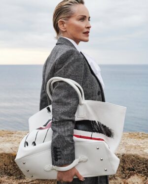 Sharon Stone Instagram - A landscape suspended between sky and sea. Sharon Stone stars in the newest Antonio Marras Fall Winter 25 campaign, wearing a Prince of Wales tailored suit, paired with the painted Alma bag. Captured in Alghero, the hometown of Antonio Marras in Sardinia. @antoniomarrasofficial 
#SharonStone #AntonioMarras #adv #AMFallWinter25