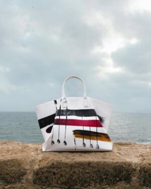 Sharon Stone Instagram - A landscape suspended between sky and sea. Sharon Stone stars in the newest Antonio Marras Fall Winter 25 campaign, wearing a Prince of Wales tailored suit, paired with the painted Alma bag. Captured in Alghero, the hometown of Antonio Marras in Sardinia. @antoniomarrasofficial 
#SharonStone #AntonioMarras #adv #AMFallWinter25