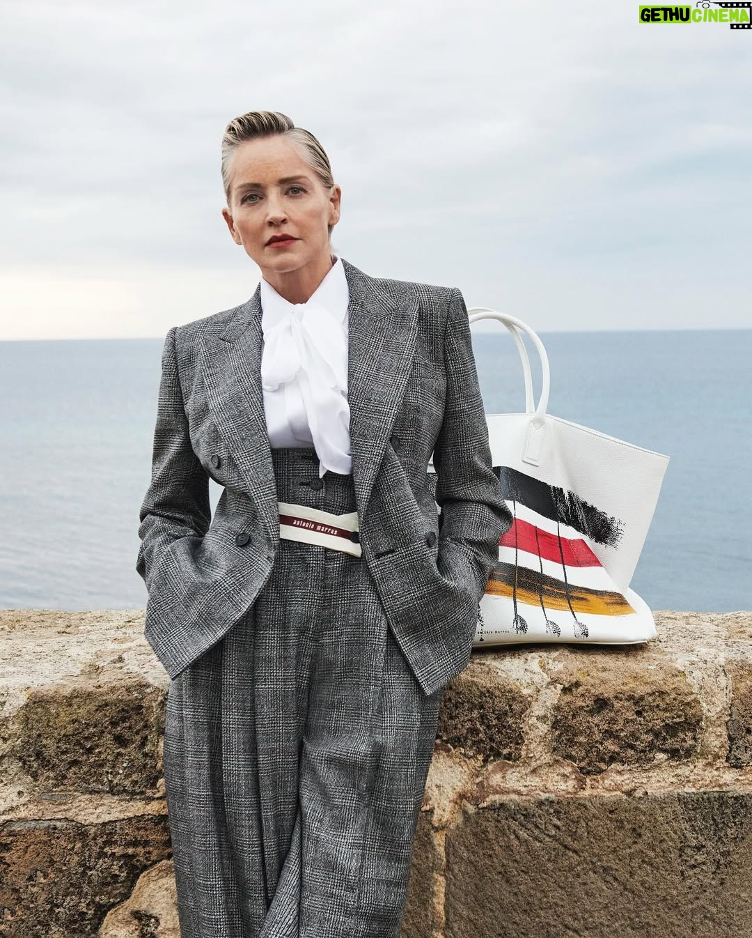 Sharon Stone - 35.6K Likes - A landscape suspended between sky and sea. Sharon Stone stars in the newest Antonio Marras Fall Winter 25 campaign, wearing a Prince of Wales tailored suit, paired with the painted Alma bag. Captured in Alghero, the hometown of Antonio Marras in Sardinia. @antoniomarrasofficial 
#SharonStone #AntonioMarras #adv #AMFallWinter25