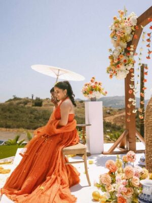 Sunaina Khera Instagram - A bride who made her mehendi truly her own. She chose our custom word lehenga in orange with a 3D floral blouse and designed just for her. This one is extra special for us too, as it’s the first time we brought personalized words to life in Hindi. Couldn’t have asked for a more beautiful beginning to this idea.✨🧡
Bride: @xxaishwaryaxx
Groom: devalgupta
Photographer: @theblemishedtales
Planner: @apanacheaffair
Florals: @tbdsandiego
HMU: @bridesbyroupak