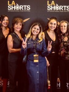 Anousha Instagram - .🎥🎬🎞️
Our film premiered at LA Shorts after nearly two years of dreaming, filming, and bringing it to life. To anyone in the film industry: this process takes time. It’s rarely easy, but storytelling is sacred. Since the beginning of humanity, stories have helped us make sense of life. They give us hope, remind us we’re not alone, and inspire us to keep going.
Your story matters. There’s space for it. This world is abundant, we need more voices, more visions, more truth.
Thank you to the cast and crew for creating such a safe, beautiful space for us to be vulnerable. Playing Mina was an honor. She’s fierce, raw, and deeply rooted in justice, and I carry her with me still.
To our brilliant director, @sahar_ghorishi.x ,thank you for pouring your soul into this. The silence in the theater, the tears in the room, you created that. And to my family and my partner: thank you for believing in me, always.
______________________________________________
فیلم ما بعد از نزدیک به دو سال تلاش، فیلم‌برداری و ساخت، در جشنواره‌ی LA Shorts اکران شد.
برای همه‌ی عزیزانی که در صنعت فیلم فعالیت می‌کنن: این مسیر، زمان‌بره و آسون نیست، اما قصه‌گویی یک کار مقدسه. از آغاز تاریخ بشر، داستان‌ها بودن که به زندگی‌مون معنا دادن. امید بخشیدن، ما رو به هم نزدیک کردن، و باعث شدن ادامه بدیم.
داستان تو مهمه. برای صدا و روایت تو جا هست. این دنیا پر از فراوانیه، ما به صداهای تازه، نگاه‌های نو و حقیقت‌های بیشتر نیاز داریم.
ممنونم از تیم تهيه كننده و عوامل که محیطی امن و زیبا برای حضور مخصوصاً بازیگران ساختن. نقش «مینا» برای من افتخاری بزرگ بود، دختری قوی، واقعی و ریشه‌دار در عدالت که هنوز در وجود من زندگی می‌کنه.
و به کارگردان بی‌نظیرمون، سحر عزیز، ممنونم که تمام قلب و روحت رو پای این فیلم گذاشتی. سکوت سالن، اشک تماشاگرها… همه از لحظه‌هایی بود که تو خلق کردی.
و در آخر، ممنونم از خانواده‌ام , پارتنرم و دوستانم که همیشه به من ایمان داشتن 🫂❤️