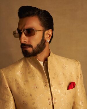 Eka Lakhani Instagram - Ranveer Singh 🤌🏻♥️

An ode to timeless Banarasi craftsmanship, Ranveer’s classic Bandhgala by @anamikakhanna.in features intricate corded detailing and refined self-embroidery, honoring the artistry at its core.

@swadesh_online’s exquisite silk-cotton Banarasi jaal is woven with iconic alfi motifs, elevated by delicate touches of red meena that carry the soul of tradition, meticulously crafted by Shamim, a third-generation maestro of Banarasi brocade weaving. 

#StylesByEka @ekalakhani
Style Team @fatimabaluchstyles @styledbyradhikadhanuka @team___e
Dress Team @_sajjad_199 @yasar_ali0007 

Photographed by @thehouseofpixels 
Hair @aalimhakim @mustaqeem_salmani
Makeup @mahadevnaik08
Managed by @rjanahavi @aarti1980
Team RS @cp_vinayak @kaushalkumar3399