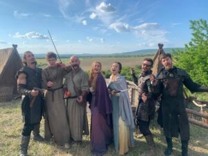 Eliza Butterworth Instagram - The 10 year anniversary of The Last Kingdom!!! ♥️⚔️♥️ Without a doubt this will forever be one of the most joyous, magnificent, magical and absolutely life changing chapters of my existence!! Any of our cast and crew can attest to this and we are connected forever through this beautiful show which was made over 8 years! The best job I will ever have! This show brought me the bestest friends anyone could dream of, the most stunning memories as well as an unbelievable education from all of the exquisite cast and crew in all things acting, filming and production. These people are magic and these photos and videos do no justice to show the years of fun and laughter we had together filming in beautiful Budapest! I started the show at age 21 and ended age 28 as a royal Saxon grandmother having the time of her life! This show allowed all of us actors to expand our range and they believed in us to carry such amazing storylines and relationships which blows my mind! Our crew and production team were exquisite in every way possible and brought every single second of this show to life! And the best part of all of these years of fun is getting to connect with our stunning fans who joined us for the epic ride and made it all possible! We love you so much! Thank you or everything!!! DESTINY IS ALL ♥️🥹♥️