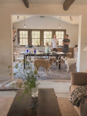 Lauren Liess Instagram - The “Whalerman’s Watch” beach cottage is almost finished just in time for the holidays! 🐳 So thankful for this chill time with the family. Sending love to you and yours this Thanksgiving! 

The design details: 
Leftover beams from the Meadow give the place those old scrap wood Outer Banks vibes with a little bit o’ those old English Lost Colony Roots. The original houses around here were made from leftover scrap wood from barns, shipwrecks etc. Still working on things like installing countertops and lighting.

Stucco walls, planked board ceilings, painted old floorboards mixed with brick and some existing furnishings (the ikea table came with the house & we had most everything in our barn!) and a couple of new pieces (the Meadow sofa from my collection with @taylorkingfurniture   an antique Swedish 1872-painted chest) have made this place into a relaxed, cozy, and flop-able beach pad. Loving it in the off-season with candles, kids and pups.  The whole renovation is featured in our “Saving Lost Cottages of the Outer Banks” video series. 🤍🌊