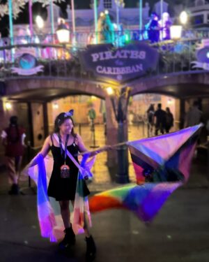 Mica Burton Instagram - the world is on fire, but hey, at least i made it to 31 as of today ✨🎂

i also got to wave around this huge gay pirate flag so honestly that’s all that matters 🩷❤️🧡💛💚🩵💜