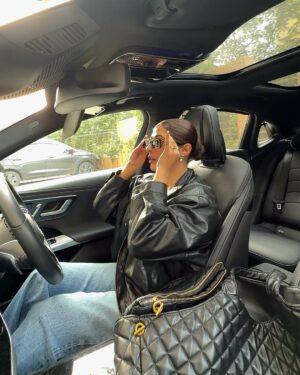 soundarya thakur Instagram - She’s focusing on her 🖤 >>>>

Outfit @zara 
Sliders - @dior 
Glasses - @balenciaga 
Earrings - @chanelofficial 
Bag -  @ysl 
Car - @mercedesbenz E450

#mercedesbenz #mercedes #E450 #luxuryride #ootd #delhiwinters #leatherjacket #urbanfashion #chicvibes  #octoberevenings #citydrive #goldenhour #sunset #soundaryathakur #formocloset
