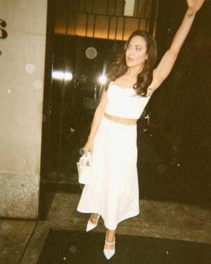Camille Guaty Instagram - beautiful @camilleguaty stars as bad ass truck driving single mom, Izzy, in the @jjabramsofficial hit thriller DUSTER. Camille describes stepping into her characters 70’s style wardrobe/hair/makeup and how playing Izzy stretched her as an actor. check the candid photo diary of her Duster press day in NYC, a detailed list of highlights from it , side passions, being a mom, partnering with @resolveorg on her quest to support women with fertility struggles as she has experienced first hand….and a most awesome bare essential……silliness! 🖤 #linkinbio 🤍
••••••••
photos/makeup: @tina_turnbow 
hair: @paulnortonhair 
stylist: @kristaroser 
dress: @halston robe: @victoriassecret white dress/jeans @veronicabeard 
#duster #70s #camilleguaty #crime #thriller #style #hbomax #infertility #ivf #bts
